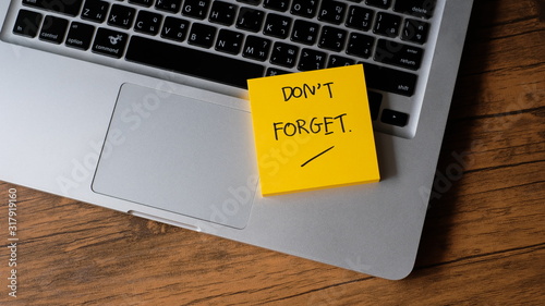 Don't forget message concept written post it on laptop keyboard photo