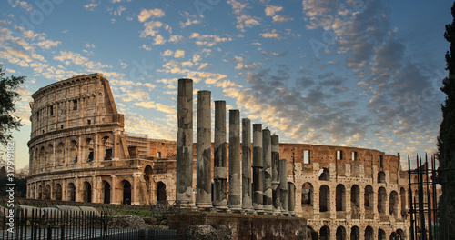 Nice view of the Colosseum whit the columns and cloud sky in the background.