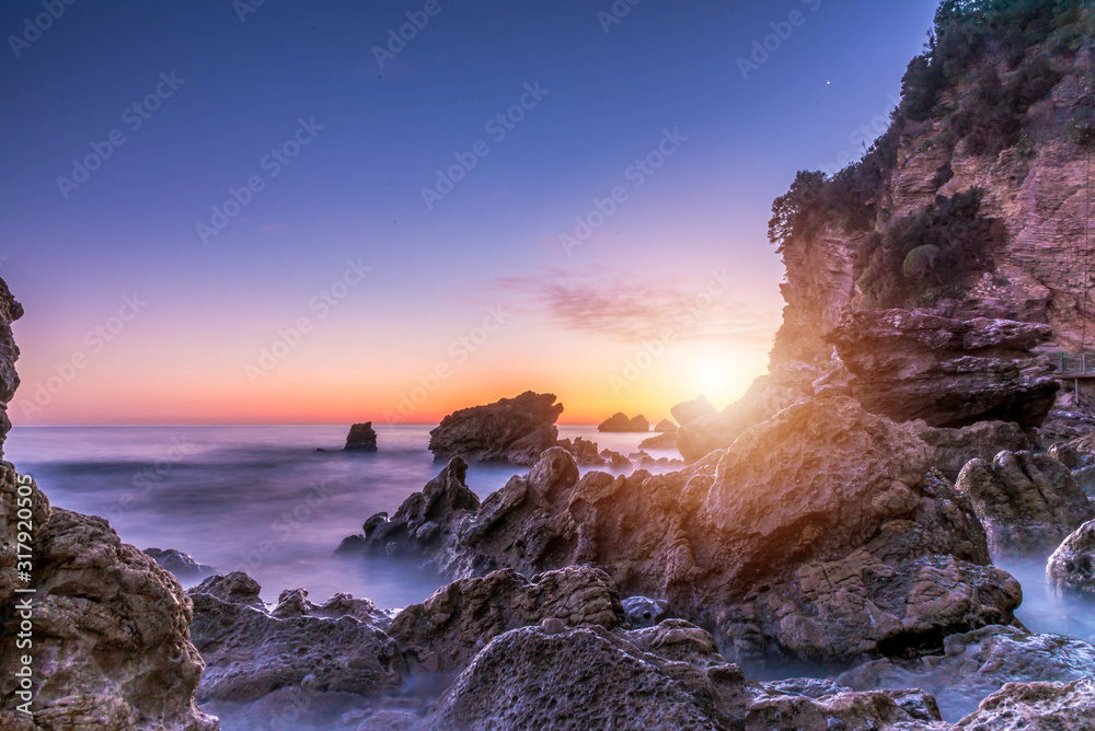 Sea scape with rocks, long exposure.Tropical rocky beach at sunrise, located in Budva, Montenegro, Adratic sea.