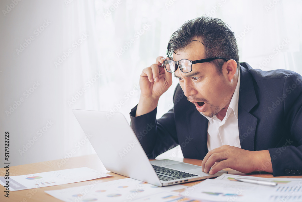 surprised face business man have seen the good news from the laptop computer , copy space - business concept surprised face business man have seen the good news from the laptop computer , copy space - business concept