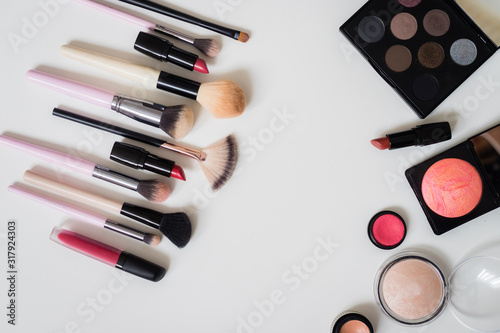 Make up concept: Professional makeup tools and accessories. Lipstick, mascara, nail polish, eyeshadow, powder, eyelash and foundation. Top view.