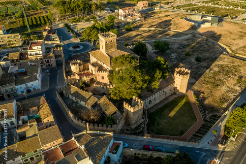 Aerial morning view of fully restored Besano castle in Valencia with battlements, towers and a keep in Spain photo