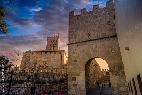 Pou medieval gate near Benisano castle in Valencia province Spain with dramatic sunset sky photo