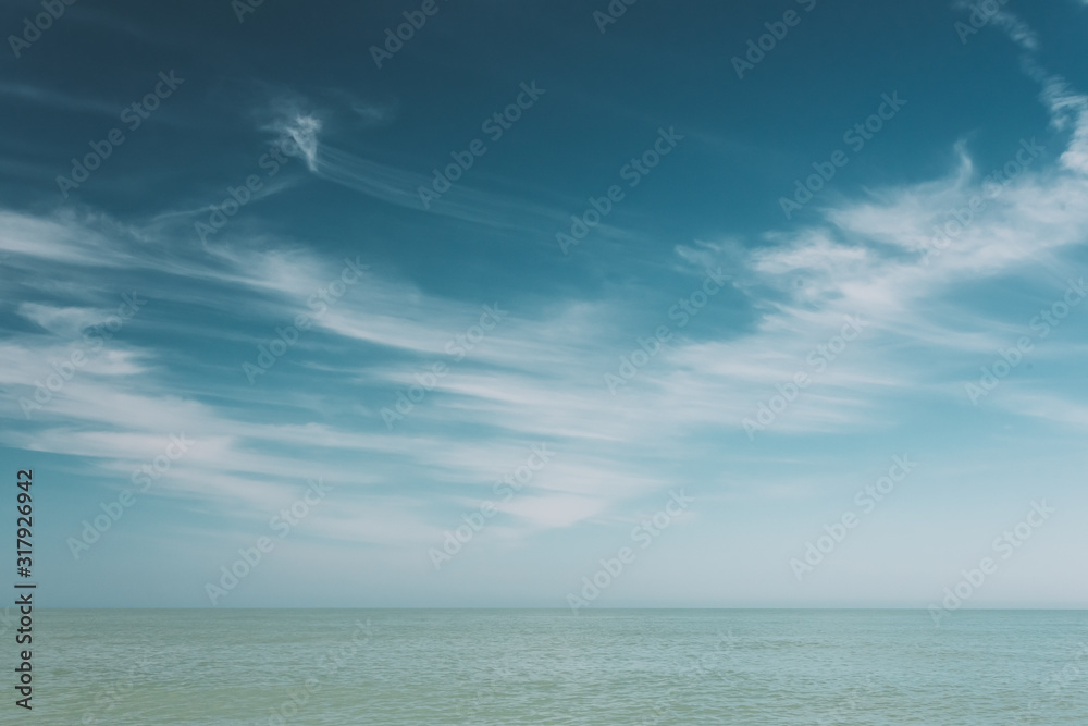 Blue Sky Over Calm Water Of Sea Ocean. Natural Background With Gently Blue Colors