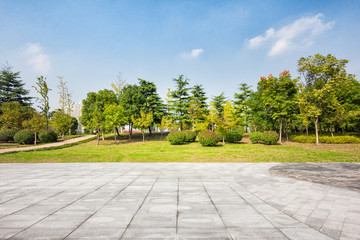 Empty floor square and playground ferris wheel in the city park