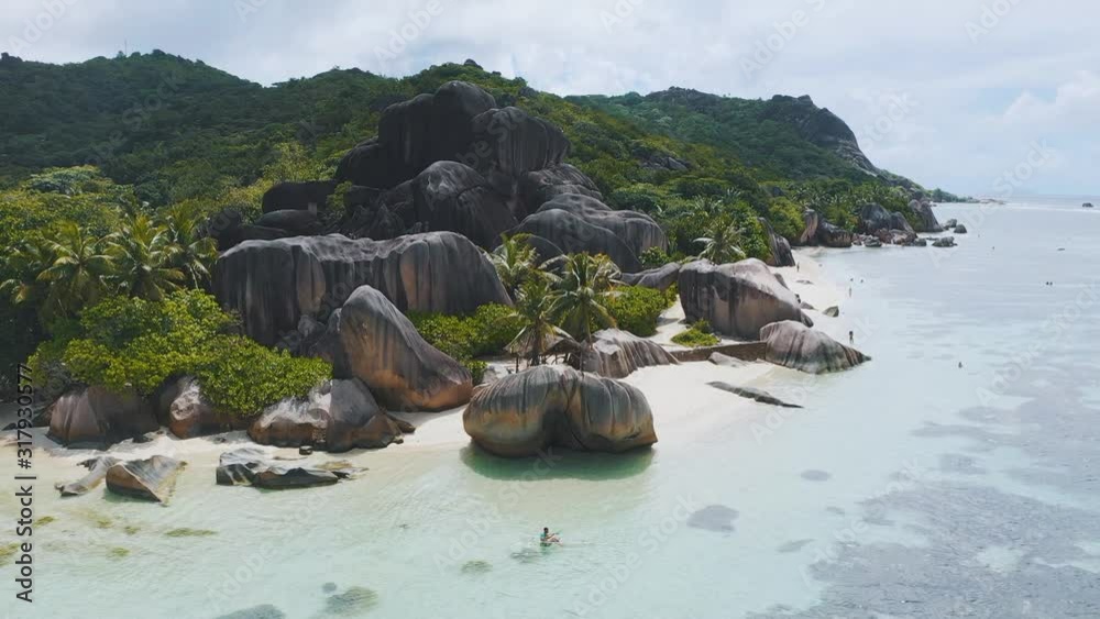 Aerial drone view on the beautiful white sand rocky beach in the seychelles, La digue silver bay
