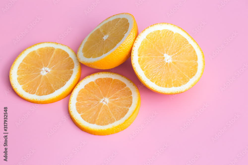 Slice of fresh orange isolated on pink background view Slice of fresh orange isolated on pink background view