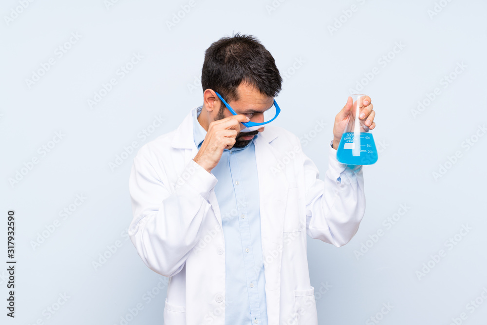 Young scientific holding laboratory flask over isolated background