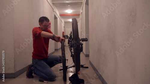 Wallpaper Mural A man is repairing a bicycle wheel. Torontodigital.ca