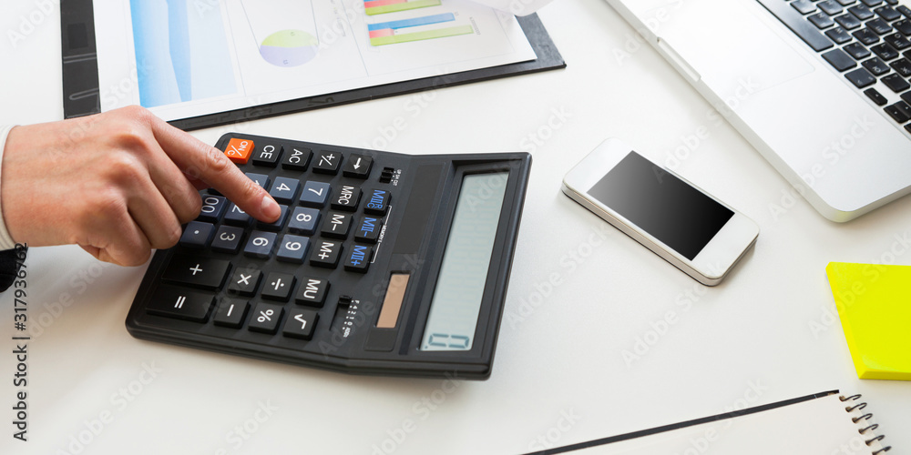Close up view of bookkeeper or financial inspector hands making report, calculating or checking balance. Close up view of bookkeeper or financial inspector hands making report, calculating or checking balance.