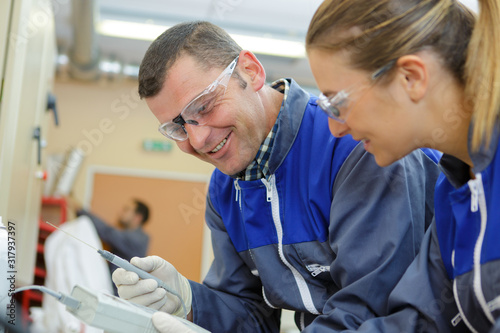 portrait of mechanical workers measuring something