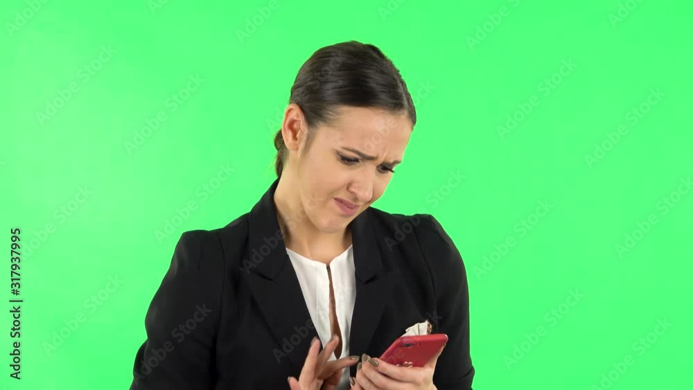 Girl angrily texting on her phone. Green screen Girl angrily texting on her phone. Green screen