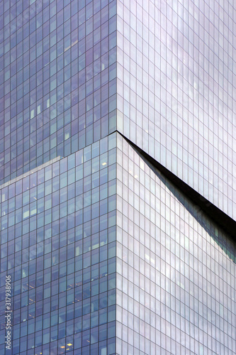 Abstract architecture. Angle modern business building skyscraper blue glass. Glass blue square Windows of  modern city business building skyscraper. The texture of the windows of the building. 