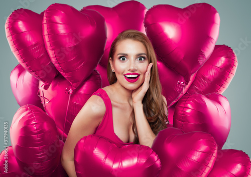 Nice girl with bright pink heart balloons portrait