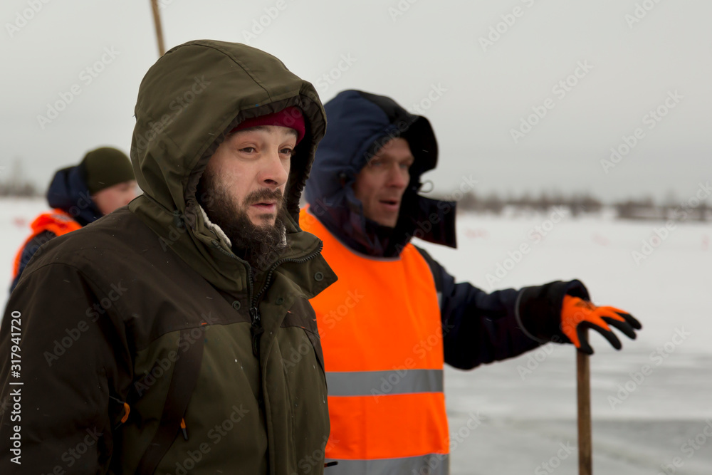 Two workers in overalls at a construction site