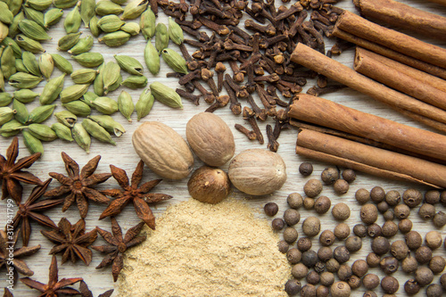 Flat Lay herbs and spices for mulled wine. Clove, cinnamon, star anise, allspice, nutmeg, cardamom, ginger, east, indian pepper