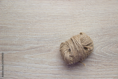 Skein of twine, rope on a beige wooden background. Flat Lay