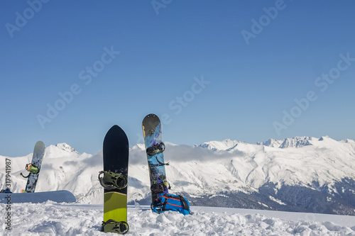 snowboards stands on the background of the snowy mountains of the Caucasus, the ski resort Rosa Khutor