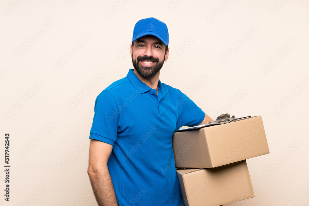 Delivery man with beard over isolated background laughing Delivery man with beard over isolated background laughing