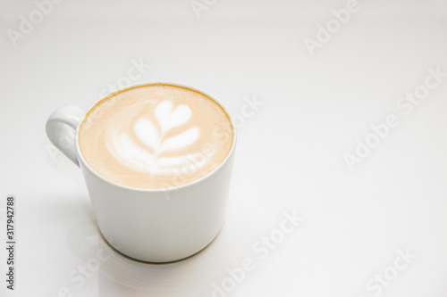 coffee with heart pattern on the foam in white cup