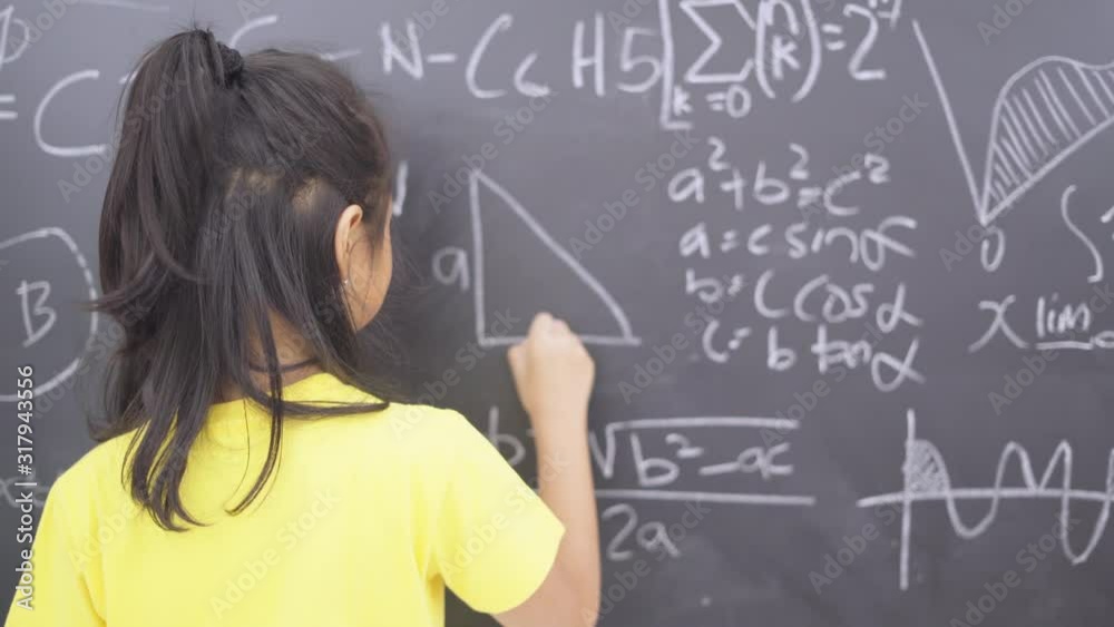 Female student writing triangle formula in class Female student writing triangle formula in class
