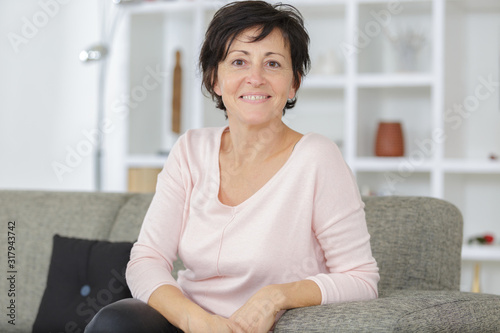 happy mature woman sitting on sofa Free Download happy mature woman sitting on sofa - GFXLoad