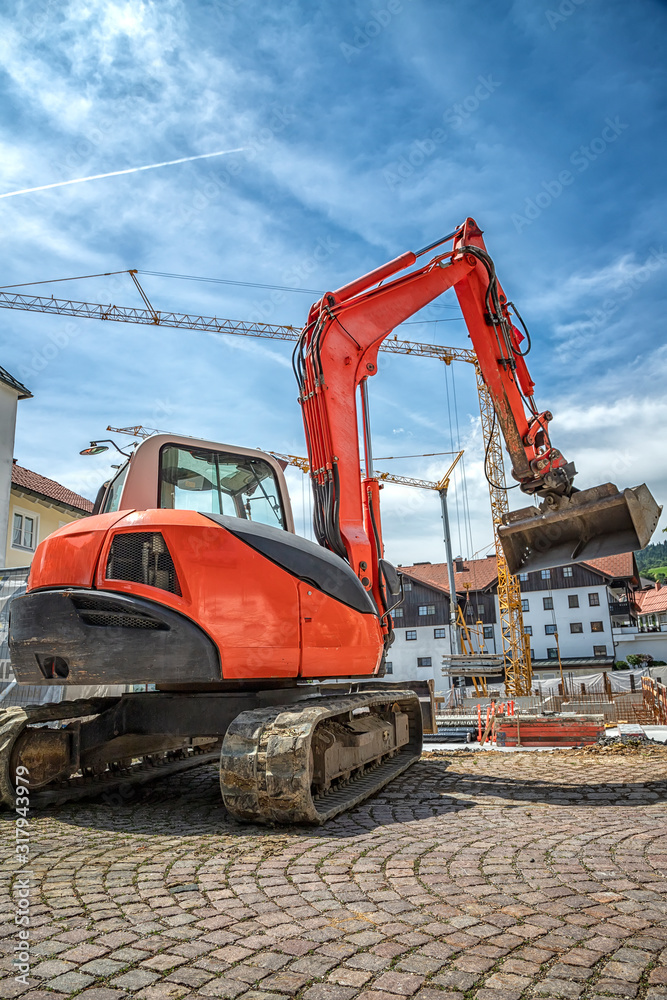 A big red excavator working at the construction site. Vintage view A big red excavator working at the construction site. Vintage view