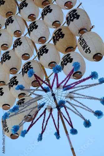 Akita, Japan - August 3, 2018: Kanto Matsuri, the pole lantern festival. Performers balance kanto, long bamboo poles with paper lanterns, weighing 50 kilograms and measuring up to 12 meters long.