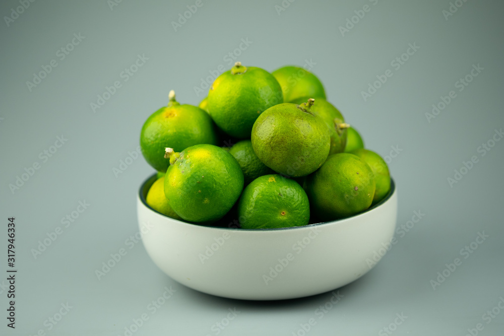 Fresh green limes. Food ingredient for sour taste. Fresh green limes. Food ingredient for sour taste.
