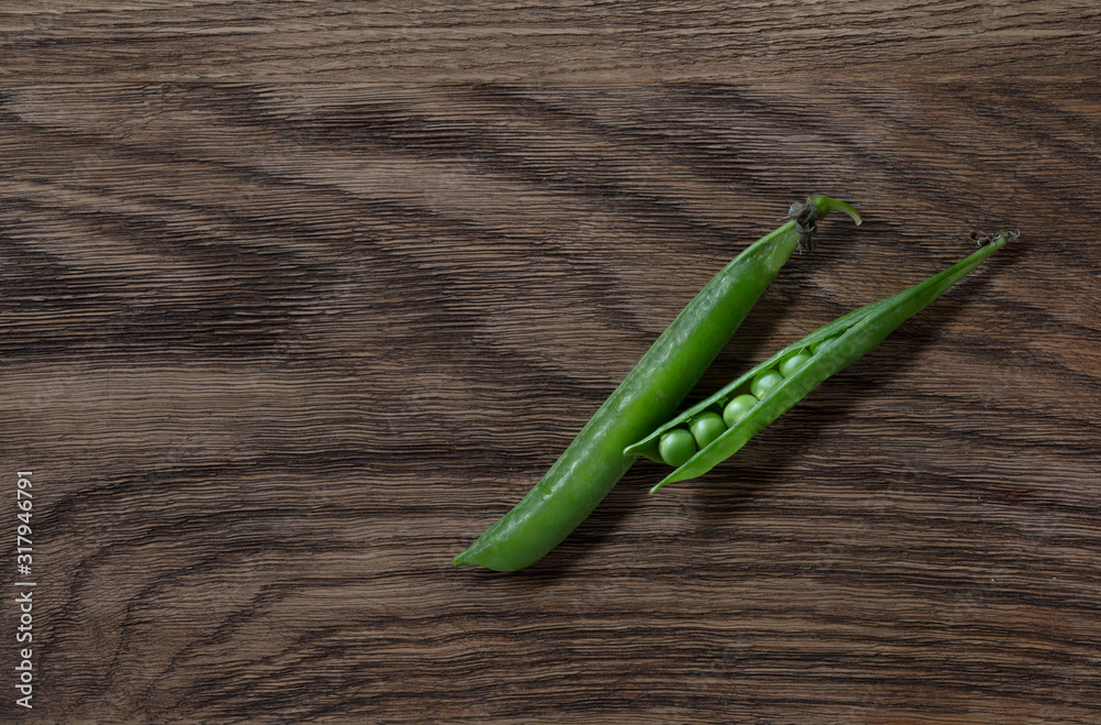 Fresh  pea pods on oak background. High resolution.