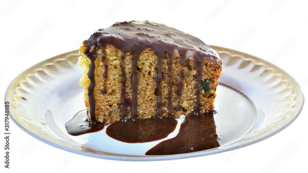 Sponge cake with chocolate icing on a plate isolated Sponge cake with chocolate icing on a plate isolated