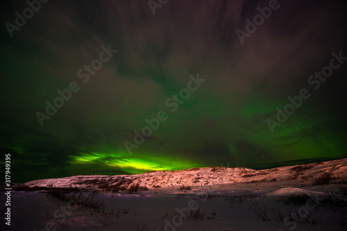 hills, clear starry sky and colorful Northern lights, an incredible natural phenomenon © Павел Чигирь