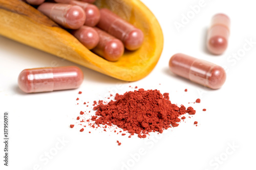 Red yeast rice or angkak or kojic rice powder and supplemet capsule on white isolated background