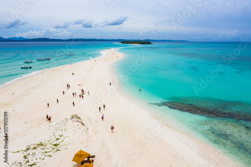 Fototapeta Naklejka Na Ścianę i Meble -  Visitors on the Sandy Tongue in Turquoise Waters of Nosy Iranja, Madagascar