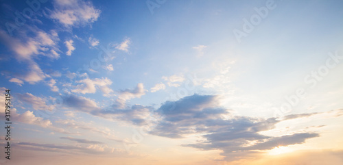 Blue sky clouds background. Beautiful landscape with clouds and orange sun on sky