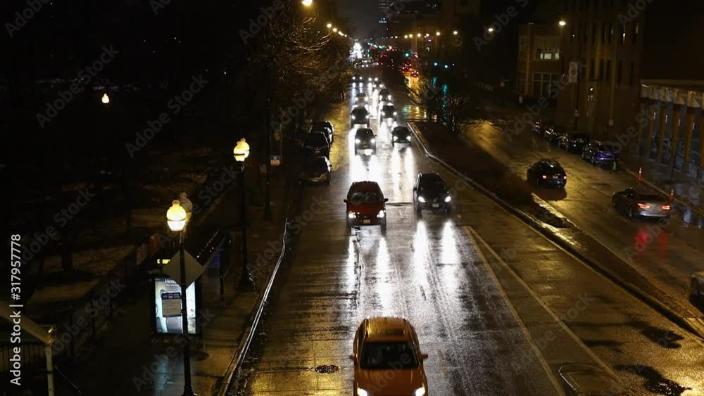 cars driving along the road at night in a urban community in the ...