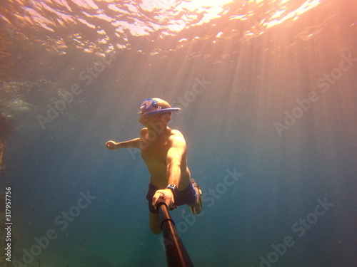 underwater man snorkeling in the sea withcrystal-clear waters concept of holiday relax summer beach diver in the sea