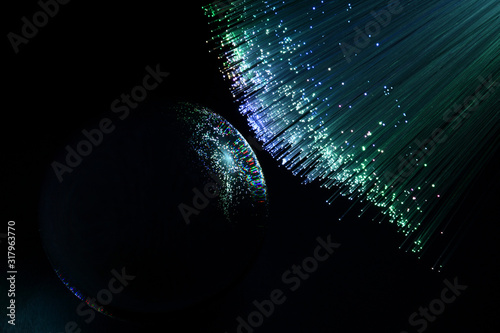abstract background with colored fibers optics reflected on glass sphere