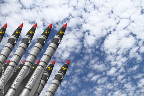 Atomic rockets earth - air directed upwards against a bright sky with white clouds. Atomic warfare concept.