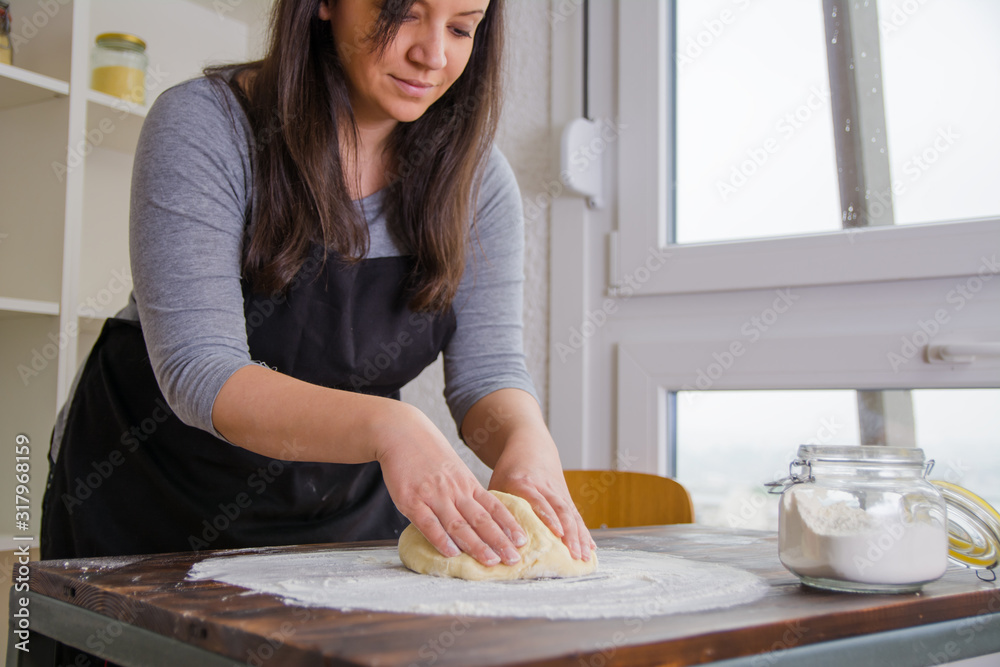 Beautiful woman preparing and kneading dough for Apple Pie