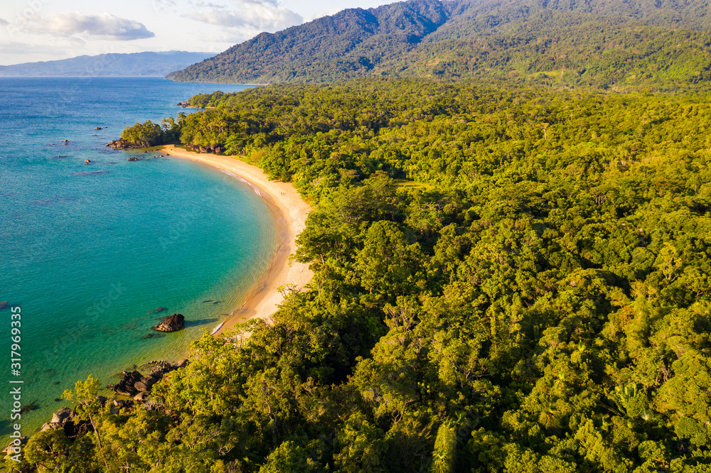 Aerial view of remote beach squeezed between coral reef and primary rainforest, Tampolo, Masoala National Parl, Madagascar - obrazy, fototapety, plakaty 
