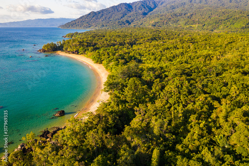 Aerial view of remote beach squeezed between coral reef and primary rainforest  Tampolo  Masoala National Parl  Madagascar