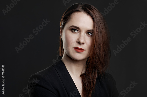 studio portrait of a girl with red lipstick on lips in a dark key