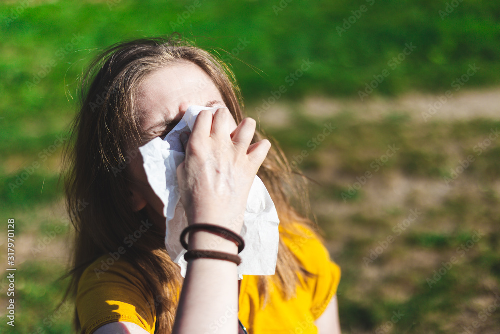 Sick woman blowing nose outside - obrazy, fototapety, plakaty 