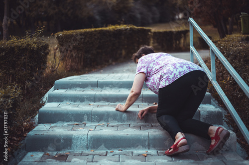 Senior woman fall on stairs outside
