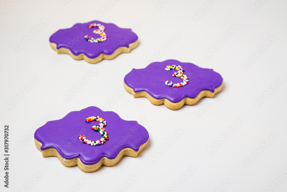 Cookies decorated in purple with sprinkles Cookies decorated in purple with sprinkles