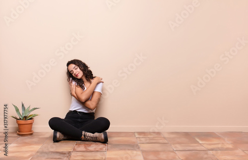 Quadro su tela young pretty woman feeling in love, smiling, cuddling and hugging self, staying