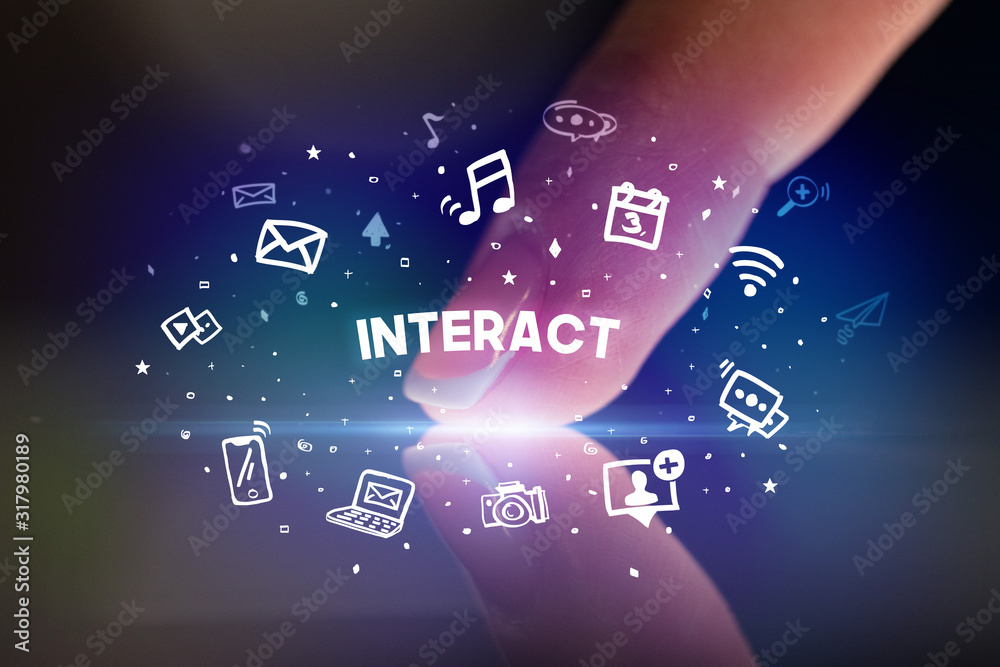 Finger touching tablet with drawn social media icons and INTERACT inscription, social networking concept
