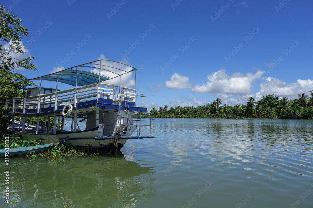 Alagoas/Brazil: wooden boats parked on the edge of a tropical river