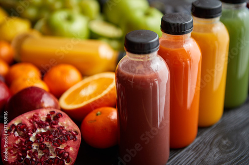 Colorful bottles filled with fresh fruit and vegetable juice or smoothie